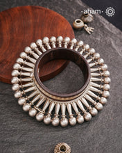 Handcrafted vintage kada with wood and silver detailing.
Beautiful piece from a bygone era, that bring back memories and stories of that time.
Origin: Rajasthan.