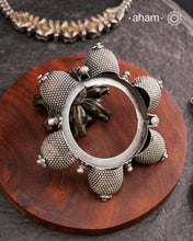 Vintage silver kada with intricate work, handcrafted by skilful artisans.Beautiful piece from a bygone era, that bring back memories and stories of that time. The Naugari Kada is a Two part bracelet with projected simulated gajre balls made from stamped silver sheet.