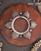 Vintage silver kada with intricate work, handcrafted by skilful artisans.Beautiful piece from a bygone era, that bring back memories and stories of that time. The Naugari Kada is a Two part bracelet with projected simulated gajre balls made from stamped silver sheet.