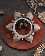 Vintage silver kada with intricate work, handcrafted by skilful artisans.Beautiful piece from a bygone era, that bring back memories and stories of that time. The Naugari Kada is a Two part bracelet with projected simulated gajre balls made from stamped silver sheet.
