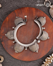 Vintage silver kada with intricate work, handcrafted by skilful artisans.Beautiful piece from a bygone era, that bring back memories and stories of that time. The Naugari Kada is a Two part bracelet with projected simulated gajre balls made from stamped silver sheet.
