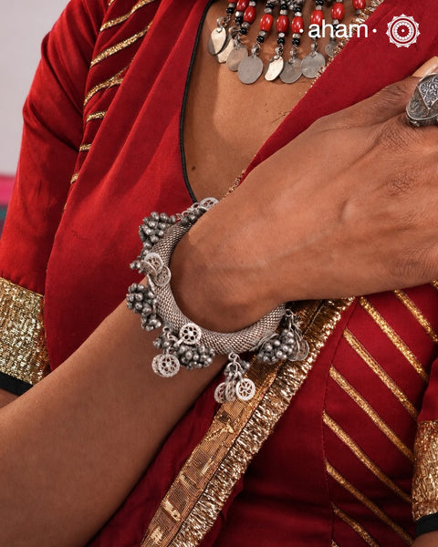 A true Catalogue rare piece. One of its kind.Origin: RajasthanA statement vintage silver&nbsp;kada&nbsp;with knitted wire flexible tube silver and adorned with ghungroos. Intricate workmanship handcrafted&nbsp;by skilful artisans.&nbsp;Beautiful piece from a bygone era, that bring back memories and stories of that time.The price is for one piece only.
