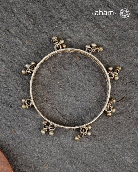 Tribal silver bangle in size 2.5 with little ghungroos. Comes as a single piece