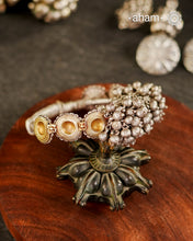 Two Vintage earrings have been wrapped with silver wire and converted in to a beautiful open cuff