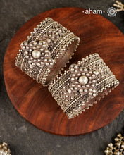 Vintage silver kada with rava and tar work handcrafted by skilful artisans. Beautiful piece from a bygone era, that bring back memories and stories of that time.
Price is for a pair. Incase you wish to buy a single piece please get in touch at 8884445300
