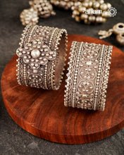 Vintage silver kada with rava and tar work handcrafted by skilful artisans. Beautiful piece from a bygone era, that bring back memories and stories of that time.
Price is for a pair. Incase you wish to buy a single piece please get in touch at 8884445300
