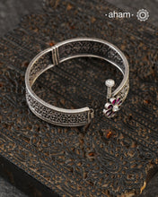 This handcrafted bangle showcases the exceptional skill of Kolhapur's master karigars, created entirely from 92.5 sterling silver with striking kemp stone accents.The bangle demonstrates superior craftsmanship through its precise construction and refined finish. Kemp highlights add textural depth and visual interest to the classic kada silhouette. An investment piece that honours traditional jewellery-making heritage while offering versatile styling for both formal occasions and daily adornment.
