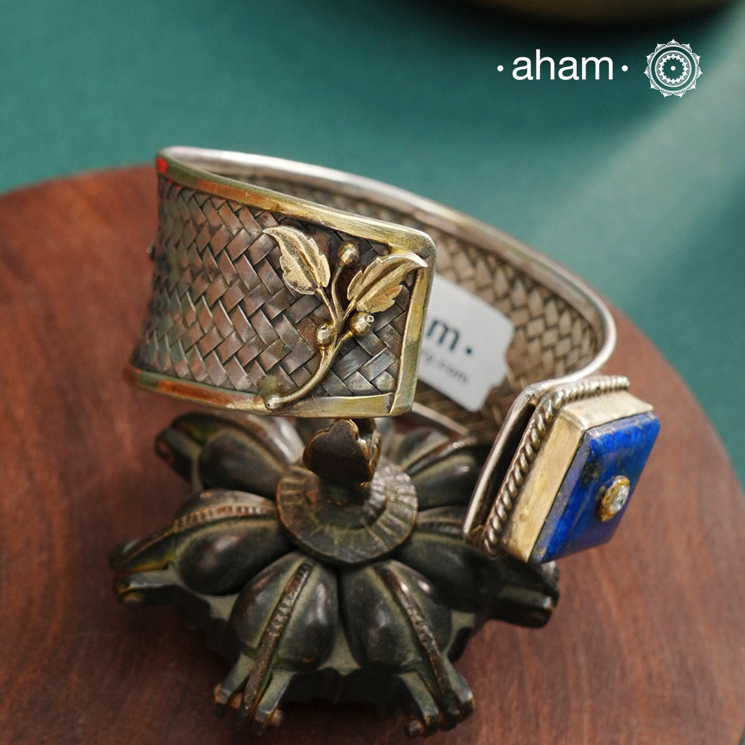 One of a kind statement wearable art pieces.Silver hand kada with a beautiful weave pattern, gold highlights and lapiz stone 