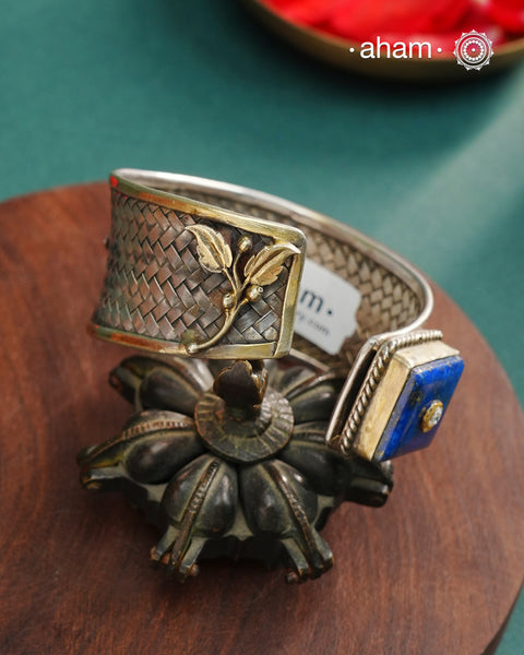 One of a kind statement wearable art pieces.Silver hand kada with a beautiful weave pattern, gold highlights and lapiz stone