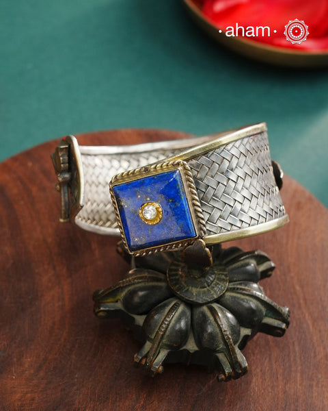 One of a kind statement wearable art pieces.Silver hand kada with a beautiful weave pattern, gold highlights and lapiz stone