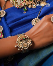 Noori two tone silver open hand cuff with a vibrant peacock motif. An eclectic mix of elements, with a play of colours, textures, forms and workmanship. Handcrafted in 92.5 Sterling Silver with two tones that make them so versatile and unique. Modern Heirloom pieces that can be worn across generations. 
