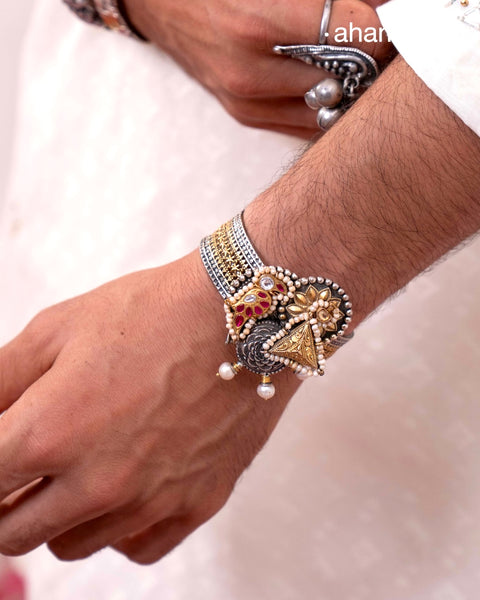 Noori two tone silver open hand cuff with a vibrant bird motif. An eclectic mix of elements, with a play of colours, textures, forms and workmanship. Handcrafted in 92.5 Sterling Silver with two tones that make them so versatile and unique. Modern Heirloom pieces that can be worn across generations.

