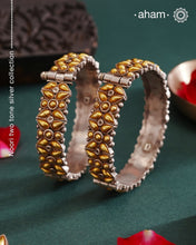 Enhance your style with the timeless elegance of the Dual Tone Silver Kada. Handcrafted by skilled karigars in Barmer, Rajasthan, this earring features traditional Bandhel work, where a thin sheet of hand beaten 22 carat gold is set on 92.5 silver using a unique wax setting technique. A classic representation of fine Indian craftsmanship