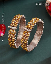 Enhance your style with the timeless elegance of the Dual Tone Silver Kada. Handcrafted by skilled karigars in Barmer, Rajasthan, this earring features traditional Bandhel work, where a thin sheet of hand beaten 22 carat gold is set on 92.5 silver using a unique wax setting technique. A classic representation of fine Indian craftsmanship