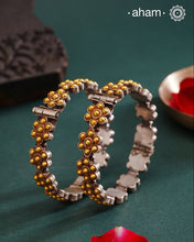 Enhance your style with the timeless elegance of the Dual Tone Silver Kada. Handcrafted by skilled karigars in Barmer, Rajasthan, this earring features traditional Bandhel work, where a thin sheet of hand beaten 22 carat gold is set on 92.5 silver using a unique wax setting technique. A classic representation of fine Indian craftsmanship.