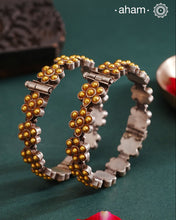 Enhance your style with the timeless elegance of the Dual Tone Silver Kada. Handcrafted by skilled karigars in Barmer, Rajasthan, this earring features traditional Bandhel work, where a thin sheet of hand beaten 22 carat gold is set on 92.5 silver using a unique wax setting technique. A classic representation of fine Indian craftsmanship.