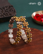 Enhance your style with the timeless elegance of the Dual Tone Silver Kada. Handcrafted by skilled karigars in Barmer, Rajasthan, this earring features traditional Bandhel work, where a thin sheet of hand beaten 22 carat gold is set on 92.5 silver using a unique wax setting technique. A classic representation of fine Indian craftsmanship.