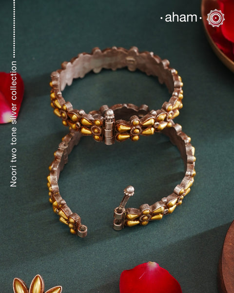 Enhance your style with the timeless elegance of the Dual Tone Silver Kada. Handcrafted by skilled karigars in Barmer, Rajasthan, this earring features traditional Bandhel work, where a thin sheet of hand beaten 22 carat gold is set on 92.5 silver using a unique wax setting technique. A classic representation of fine Indian craftsmanship.