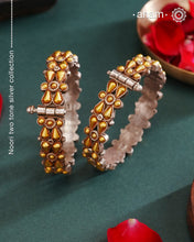 Enhance your style with the timeless elegance of the Dual Tone Silver Kada. Handcrafted by skilled karigars in Barmer, Rajasthan, this earring features traditional Bandhel work, where a thin sheet of hand beaten 22 carat gold is set on 92.5 silver using a unique wax setting technique. A classic representation of fine Indian craftsmanship.