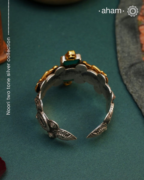 Noori two tone silver open hand cuff with a vibrant peacock motif. An eclectic mix of elements, with a play of colours, textures, forms and workmanship. Handcrafted in 92.5 Sterling Silver with two tones that make them so versatile and unique. Modern Heirloom pieces that can be worn across generations.
The price is for one piece kada only.