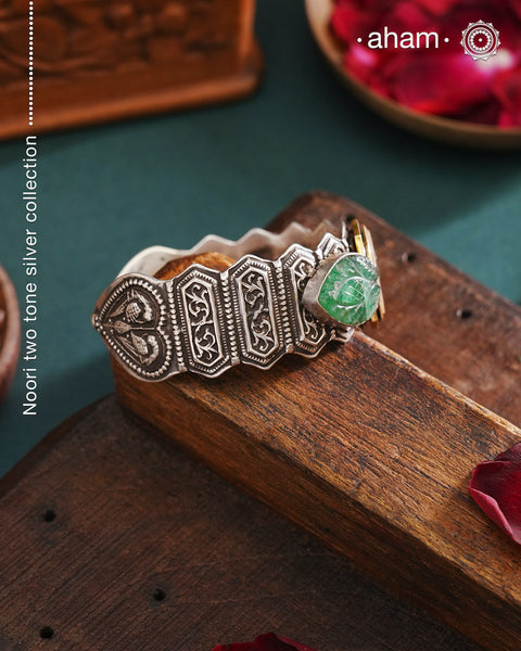 This unique Noori Two Tone Silver Hand Cuff (Open Cuff) is handcrafted using 92.5 silver, featuring a beautiful mother of pearl center and intricately carved green onyx on the sides. Truly a statement piece of wearable art.
The price is for one piece kada only