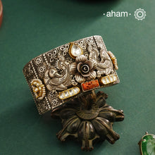Noori hand cuff with a play of colours, textures, forms and workmanship. Crafted in 92.5 Sterling Silver with two tones, coral and kundan that make them so versatile and unique.