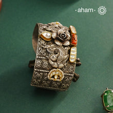 Noori hand cuff with a play of colours, textures, forms and workmanship. Crafted in 92.5 Sterling Silver with two tones, coral and kundan that make them so versatile and unique.