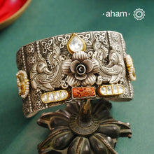 Noori hand cuff with a play of colours, textures, forms and workmanship. Crafted in 92.5 Sterling Silver with two tones, coral and kundan that make them so versatile and unique.