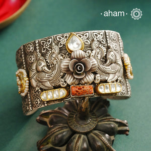 Noori hand cuff with a play of colours, textures, forms and workmanship. Crafted in 92.5 Sterling Silver with two tones, coral and kundan that make them so versatile and unique.