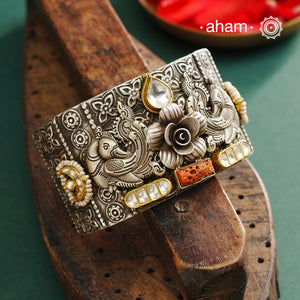 Noori hand cuff with a play of colours, textures, forms and workmanship. Crafted in 92.5 Sterling Silver with two tones, coral and kundan that make them so versatile and unique.