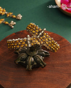 Enhance your style with the timeless elegance of the Dual Tone Silver Kada. Handcrafted by skilled karigars in Barmer, Rajasthan, this earring features traditional Bandhel work, where a thin sheet of hand beaten 22 carat gold is set on 92.5 silver using a unique wax setting technique. A classic representation of fine Indian craftsmanship.
Comes as a pair.