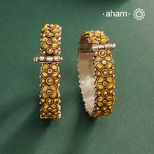 Enhance your style with the timeless elegance of the Dual Tone Silver Kada. Handcrafted by skilled karigars in Barmer, Rajasthan, this earring features traditional Bandhel work, where a thin sheet of hand beaten 22 carat gold is set on 92.5 silver using a unique wax setting technique. A classic representation of fine Indian craftsmanship.
Comes as a pair.