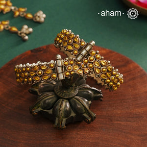 Enhance your style with the timeless elegance of the Dual Tone Silver Kada. Handcrafted by skilled karigars in Barmer, Rajasthan, this earring features traditional Bandhel work, where a thin sheet of hand beaten 22 carat gold is set on 92.5 silver using a unique wax setting technique. A classic representation of fine Indian craftsmanship.
Comes as a pair.