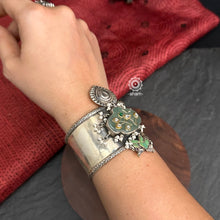 Introducing the Ira Silver HandCuff, a bold statement piece that exudes confidence. Made from 92.5 silver, it features stunning jade with intricate kundan inlay work and delicate pearls. Perfect for minimal accessorizing while still making a statement. Let your wrists do the talking with this chic and unique cuff.