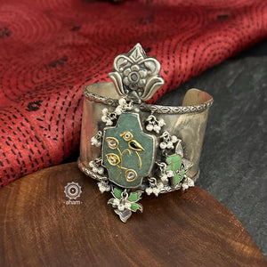 Introducing the Ira Silver HandCuff, a bold statement piece that exudes confidence. Made from 92.5 silver, it features stunning jade with intricate kundan inlay work and delicate pearls. Perfect for minimal accessorizing while still making a statement. Let your wrists do the talking with this chic and unique cuff.