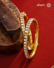 A set of 2 Moissanite kadas that are expertly crafted from 92.5% sterling silver with fine gold polish finish, showcasing a refined and elegant appearance. They are beautifully set with brilliant moissanite stones that closely mimic the sparkle of real diamonds, adding exceptional brilliance. The openable size 2.4 design offers a comfortable and adjustable fit, making this piece a sophisticated addition to any jewellery collection.