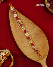 Handcrafted in 92.5 silver with a gold polish finish, this elegant bracelet features dazzling moissanite stones, floral motifs, and vibrant red accents. A timeless statement piece designed to elevate festive, wedding, and occasion wear.