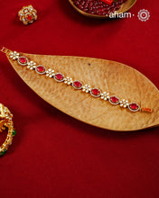 Handcrafted in 92.5 silver with a gold polish finish, this elegant bracelet features dazzling moissanite stones, floral motifs, and vibrant red accents. A timeless statement piece designed to elevate festive, wedding, and occasion wear.