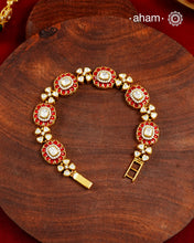 Handcrafted in 92.5 silver with a gold polish finish, this elegant bracelet features dazzling moissanite stones, floral motifs, and vibrant red accents. A timeless statement piece designed to elevate festive, wedding, and occasion wear.