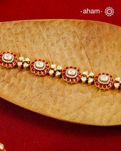 Handcrafted in 92.5 silver with a gold polish finish, this elegant bracelet features dazzling moissanite stones, floral motifs, and vibrant red accents. A timeless statement piece designed to elevate festive, wedding, and occasion wear.