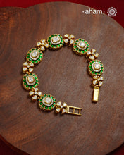 Handcrafted in 92.5 silver with a gold polish finish, this elegant bracelet features dazzling moissanite stones, floral motifs, and vibrant green accents. A timeless statement piece designed to elevate festive, wedding, and occasion wear.