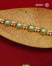Handcrafted in 92.5 silver with a gold polish finish, this elegant bracelet features dazzling moissanite stones, floral motifs, and vibrant green accents. A timeless statement piece designed to elevate festive, wedding, and occasion wear.
