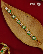 Handcrafted in 92.5 silver with a gold polish finish, this elegant bracelet features dazzling moissanite stones, floral motifs, and vibrant green accents. A timeless statement piece designed to elevate festive, wedding, and occasion wear.