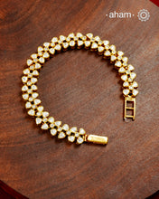 Handcrafted in 92.5 silver with a gold polish finish, this elegant tennis bracelet features dazzling moissanite stones and floral motifs. A timeless statement piece designed to elevate festive, wedding, and occasion wear.
The price is for one piece only.