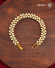 Handcrafted in 92.5 silver with a gold polish finish, this elegant tennis bracelet features dazzling moissanite stones and floral motifs. A timeless statement piece designed to elevate festive, wedding, and occasion wear.
The price is for one piece only.