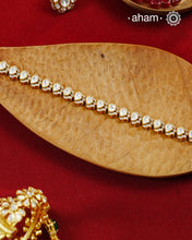 Handcrafted in 92.5 silver with a gold polish finish, this elegant tennis bracelet features dazzling moissanite stones and floral motifs. A timeless statement piece designed to elevate festive, wedding, and occasion wear.
The price is for one piece only.&nbsp;