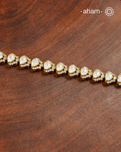 Handcrafted in 92.5 silver with a gold polish finish, this elegant tennis bracelet features dazzling moissanite stones and floral motifs. A timeless statement piece designed to elevate festive, wedding, and occasion wear.
The price is for one piece only.