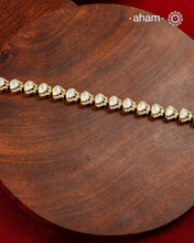 Handcrafted in 92.5 silver with a gold polish finish, this elegant tennis bracelet features dazzling moissanite stones and floral motifs. A timeless statement piece designed to elevate festive, wedding, and occasion wear.
The price is for one piece only.