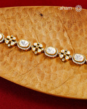 Handcrafted in 92.5 silver with a gold polish finish, this elegant tennis bracelet features dazzling moissanite stones and floral motifs. A timeless statement piece designed to elevate festive, wedding, and occasion wear.
The price is for one piece only.