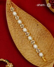 Handcrafted in 92.5 silver with a gold polish finish, this elegant tennis bracelet features dazzling moissanite stones and floral motifs. A timeless statement piece designed to elevate festive, wedding, and occasion wear.
The price is for one piece only.
